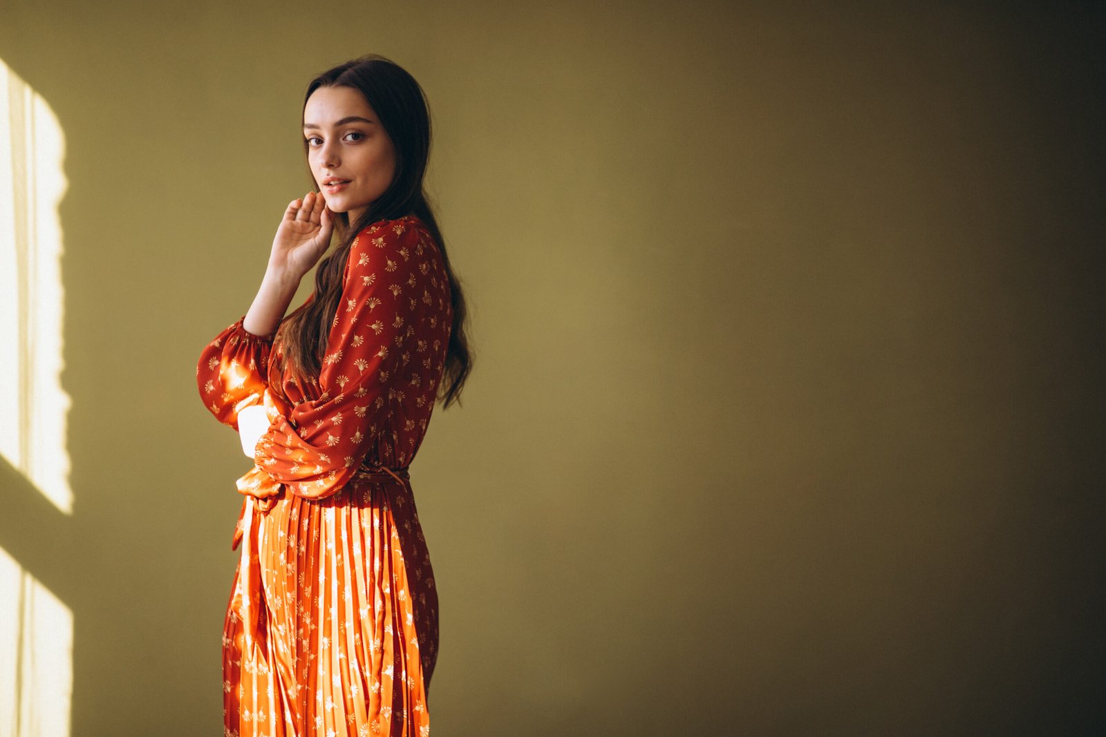 young woman in a beautiful dress in studio